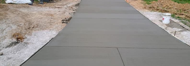 Smooth-finished concrete driveway with clean saw-cut control joints in Summertown, TN
